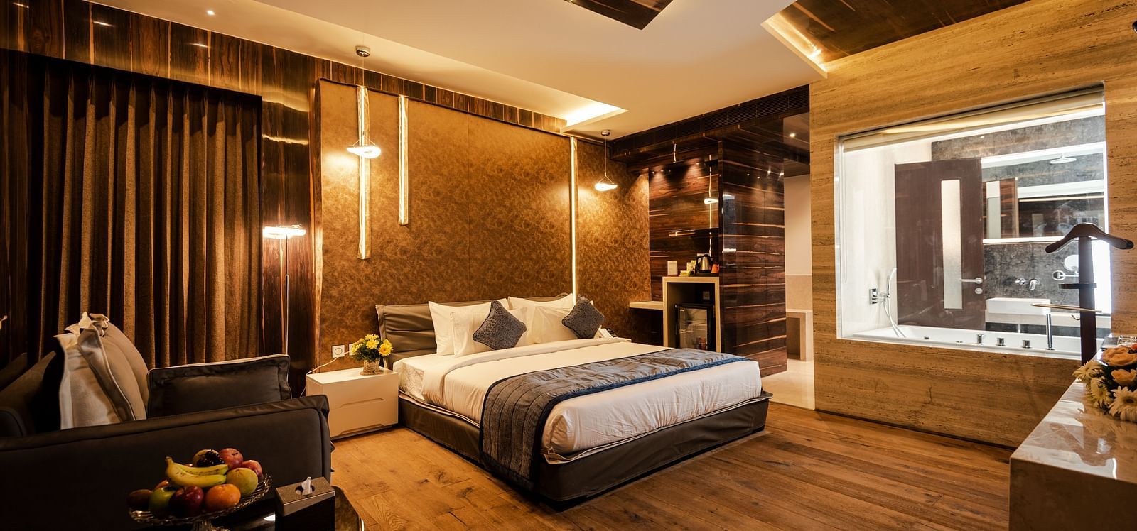 Junior Suite at Hotel Park Elanza, Coimbatore featuring a plush bed and glass-enclosed washroom