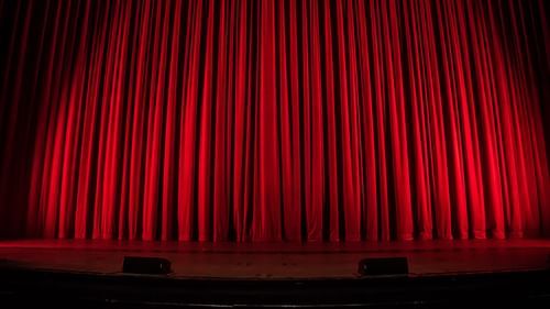 red curtain in front of a stage