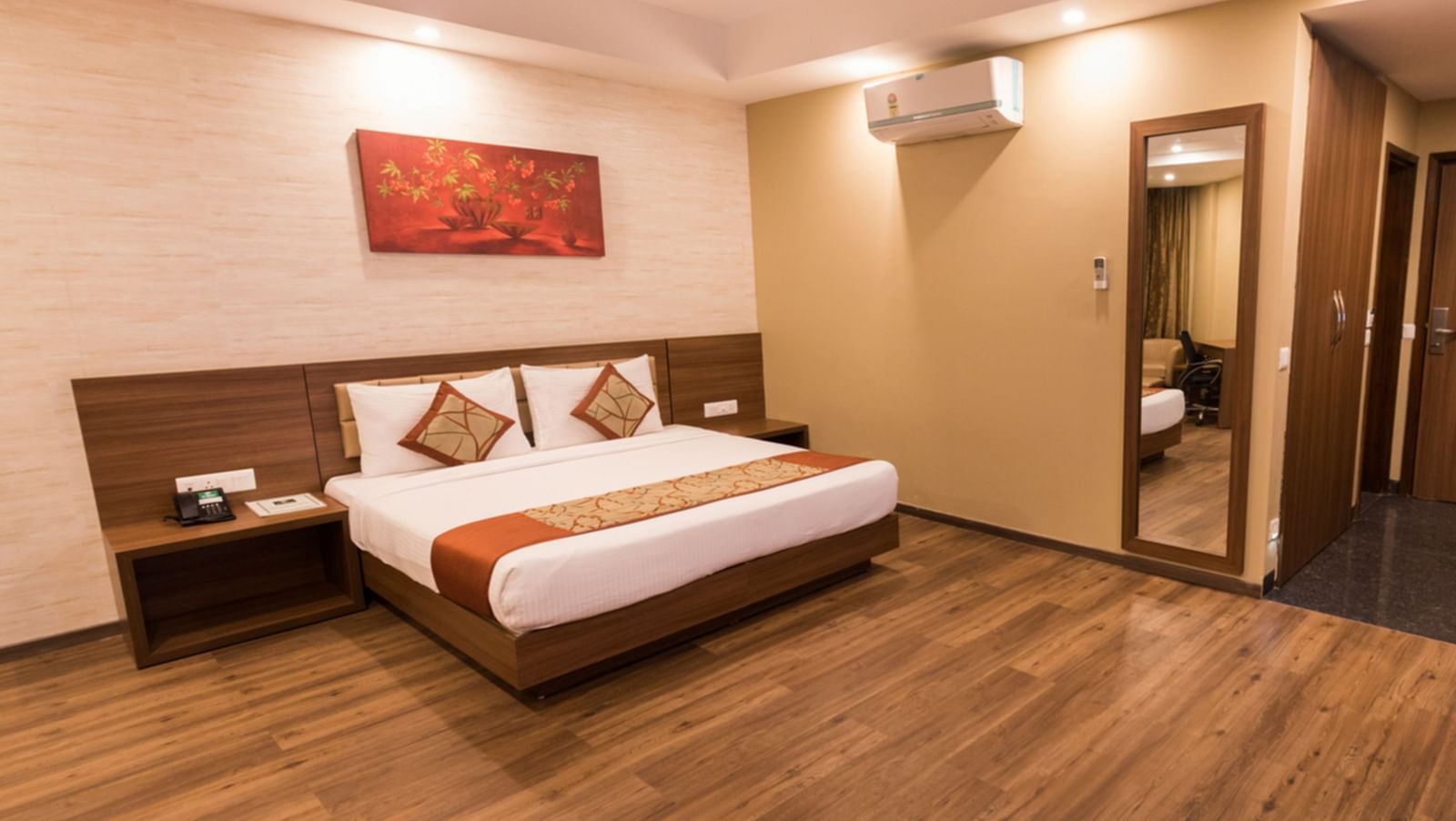 Super Deluxe Rooms with Complimentary Wi-Fi captured with a cosy bed and white linens along with a beige couch - Le ROI Digha Hotel West Bengal6