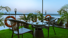 a seat for two on the outside deck overlooking river hooghly - polo floatel kolkata