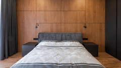 An image of a room with king size bed, bed side table, and a wardrobe