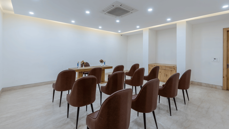 Conference room with multiple chairs and an air-conditioner, set up for a meeting or presentation at DLS The Classio