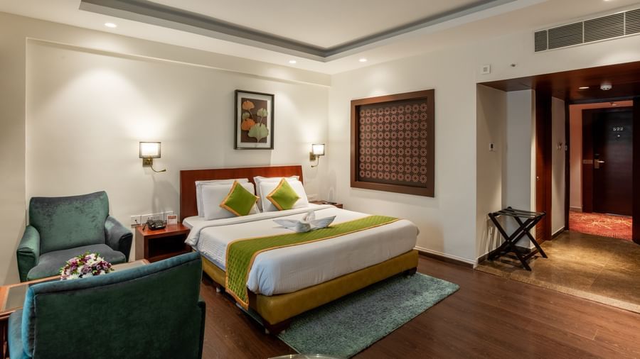 Room with modern decor, seating space, and wooden flooring at Hotel Royal Regency Chennai