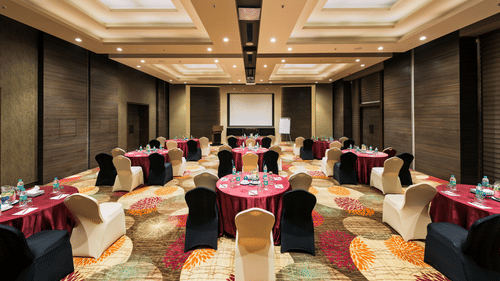 An image of the banquet hall with its seating arrangement, and decorative items - Pride Elite Phaltan
