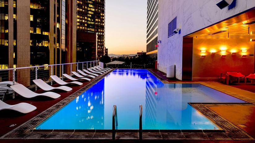 An image of a swimming pool with lounge chairs