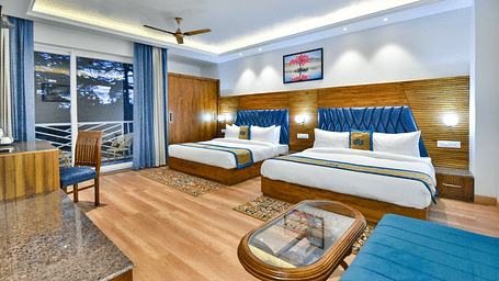 Two large beds with elegant interiors and ambient lighting in Family Suite Room at DLS Ark Holiday Inn, Banikhet.