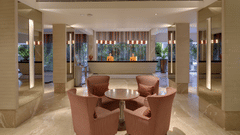  A welcoming hotel lobby with a front desk, comfortable seating, and elegant lighting, possibly at Pride Premier Pune
