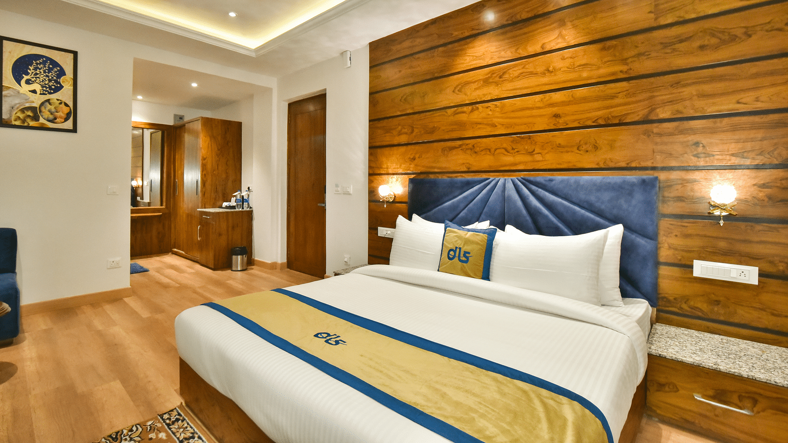 A large bed in front of the TV in Deluxe Non-view Room at DLS Ark Holiday Inn, Banikhet.