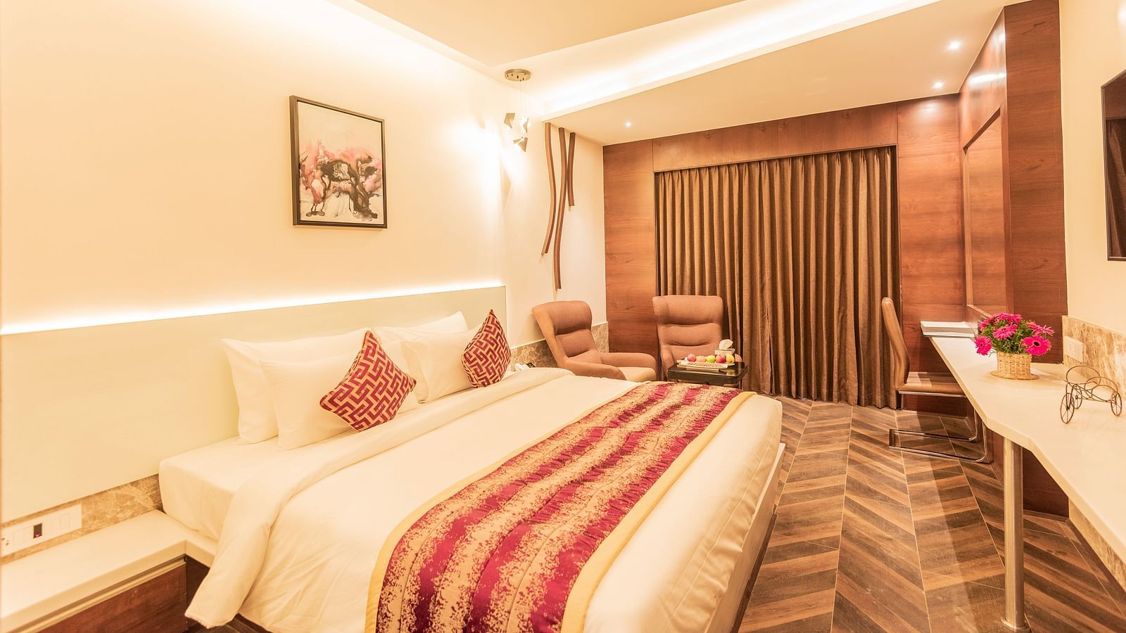 a comfy bed at Club Room featuring a red and yellow blanket and pillow at Hotel Park Elanza, Coimbatore