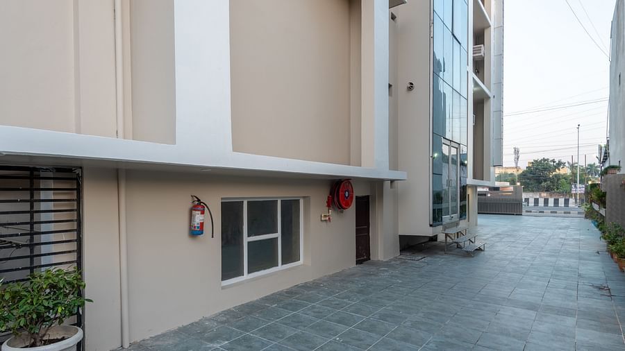 Exterior part of DLS Park Grace, Haridwar featuring tall building, and driveway.
