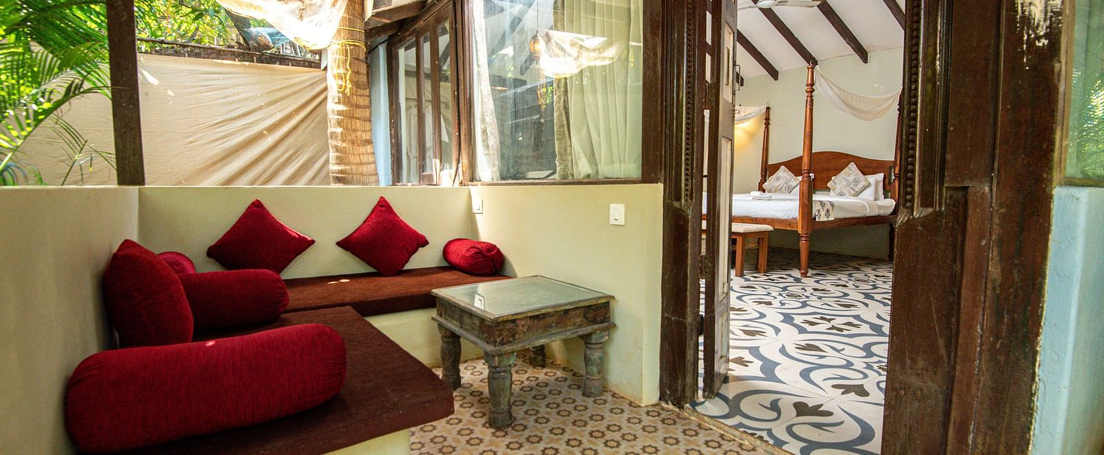 Spacious seating area with cushioned sofas and a table placed beside the sofa at De Soul Santé, Morjim.