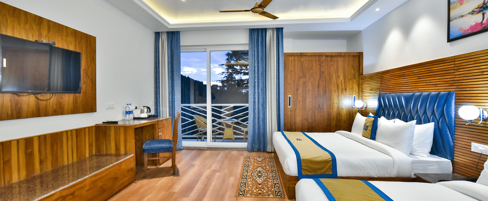 A view through the sofa of a two large beds in Family Suite Room at DLS Ark Holiday Inn, Banikhet.