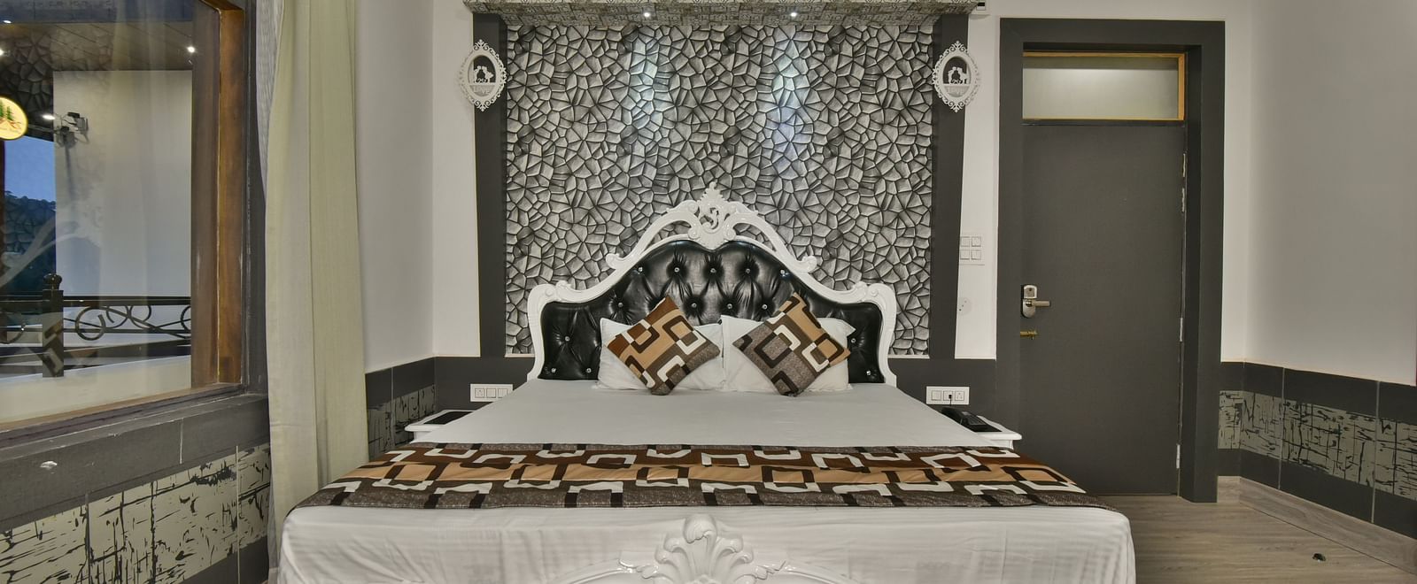 A Luxury Room at DLS Dalhousie  Valley Resort with a premium bed and balcony.