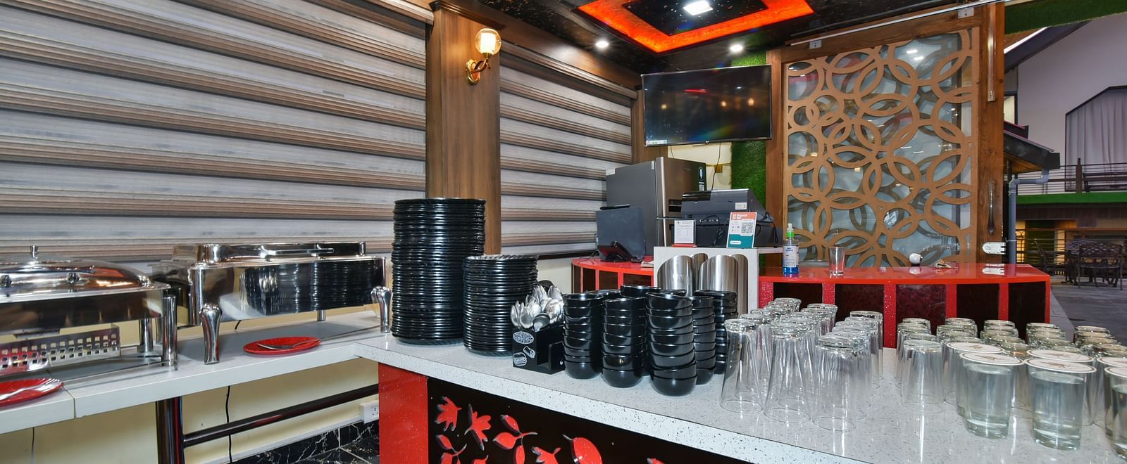 Buffet counter at DLS Dalhousie Valley Resort with various dishes and cutlery kept on the table.