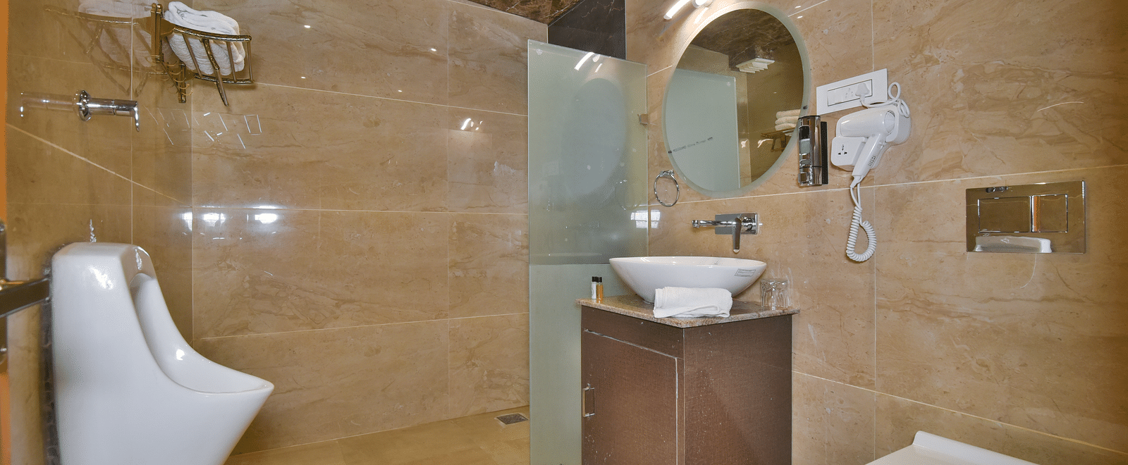 Bathroom of Super Deluxe Room at DLS Dalhousie Valley Resort with a sink mirror and a toilet.