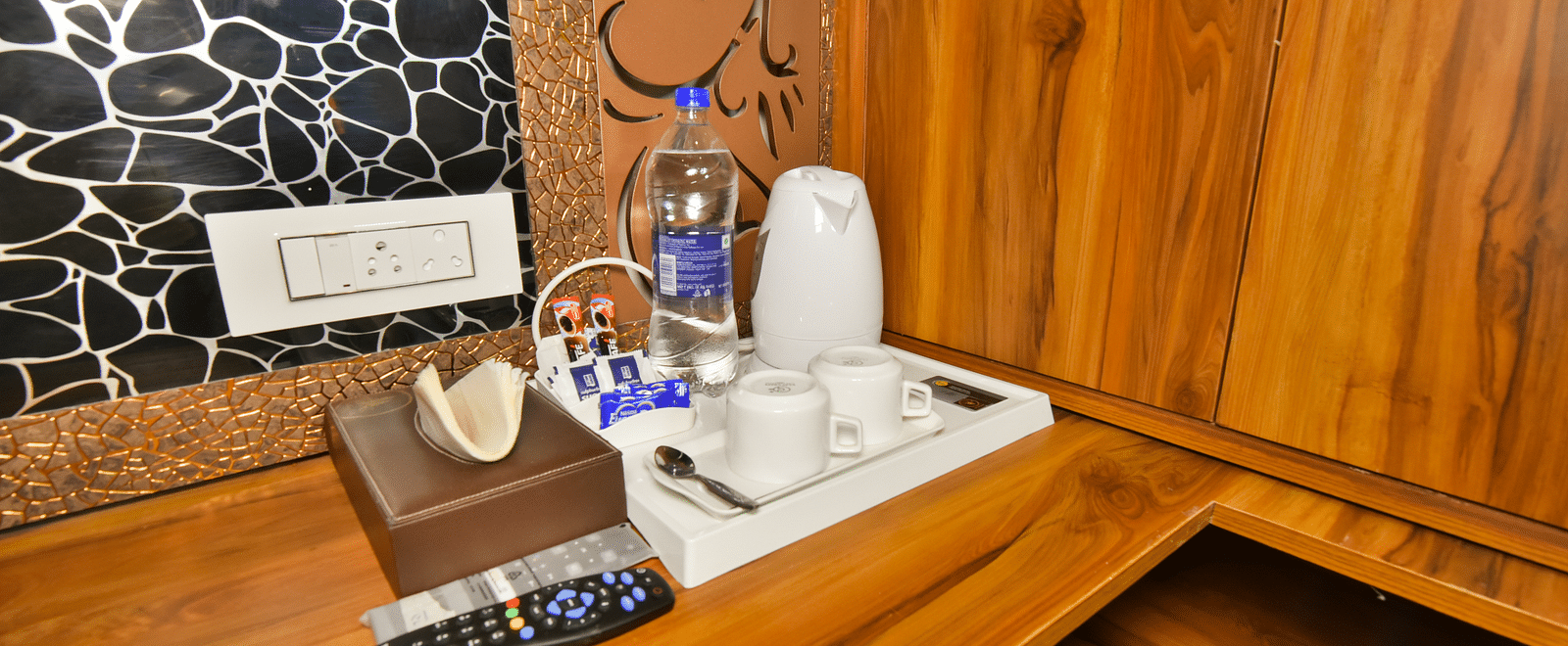 Super Deluxe room at DLS Dalhousie Valley Resort featuring room amenities like tea and coffee maker.