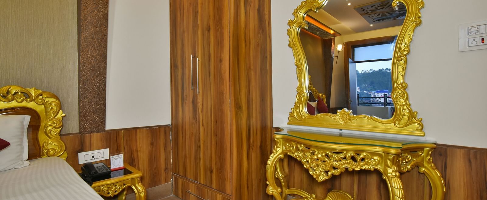 A Luxury Room at DLS Dalhousie  Valley Resort with a premium bed, wardrobe and mirror.