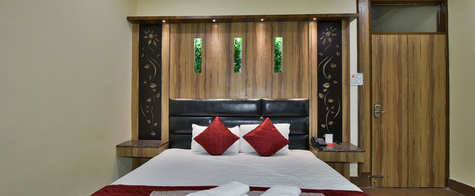 Family Suite at DLS Dalhousie Valley Resort with a king size bed and towels kept on bed.