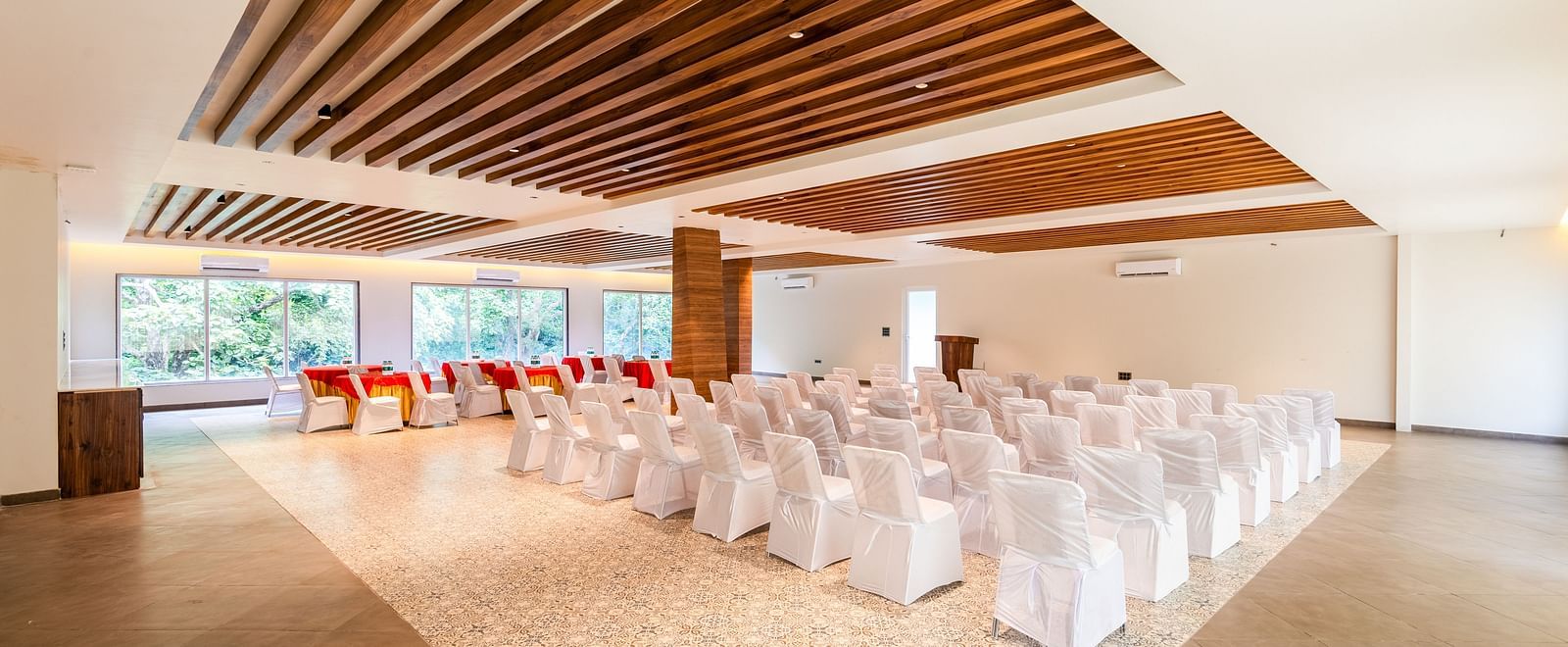 Overview of banquet hall at DLS Divine River Resort and Spa featuring  chairs table arranged in classroom setting and a stage