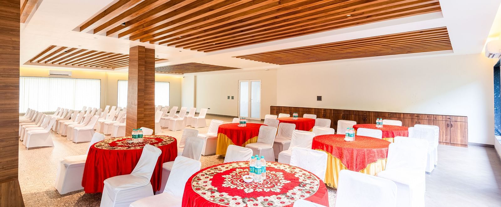 Banquet Hall at DLS Divine River Resort and Spa featuring  chairs table arranged in cluster setting.