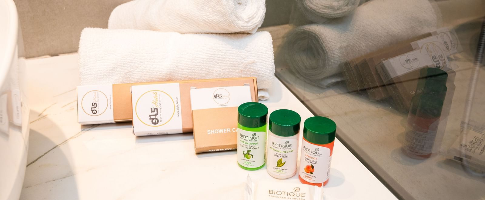 Bathroom of Deluxe Room at DLS Divine River Resort and  Spa featuring towels and shampoos.
