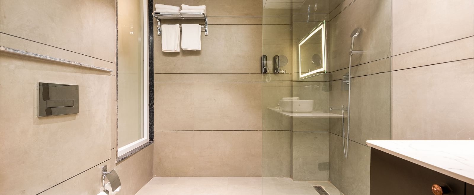Bathroom of Premium Room at DLS Divine River Resort and  Spa featuring shower, sink area, mirror and a toilet.