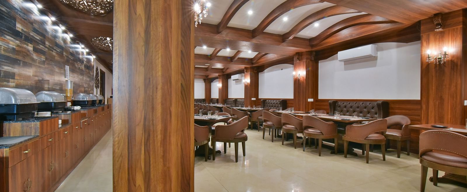 Dining seating with comfortable chairs around table at Ruttba at DLS Highland Resort and Spa, Mussoorie.