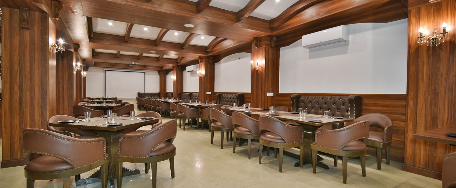 Dining seating with comfortable chairs around table at Ruttba at DLS Highland Resort and Spa, Mussoorie.