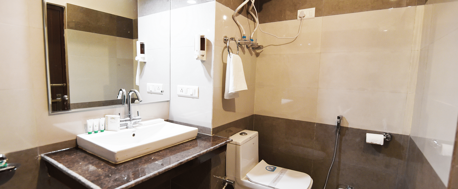 Shot of a washroom featuring a wash basin, a commode and a geyser| DLS Kapoor Resort Manali