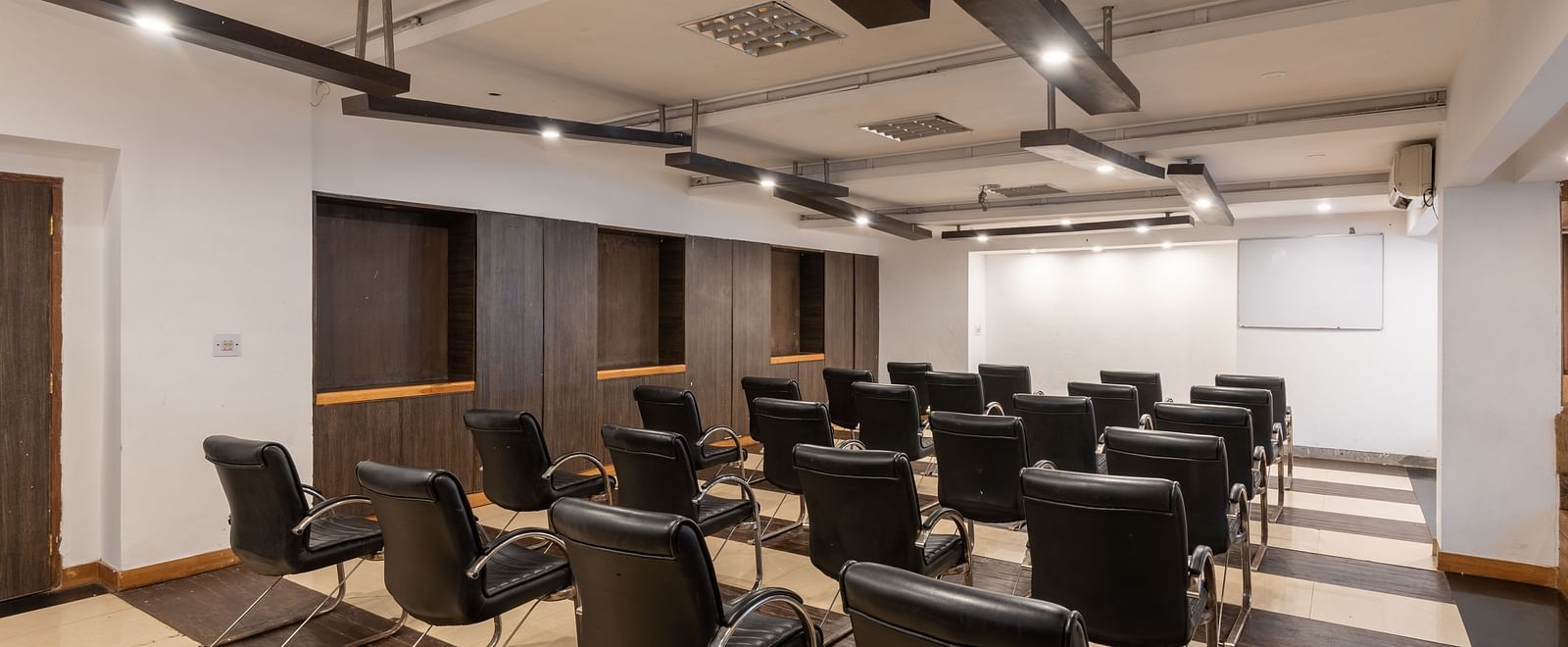 Conference Hall  at DLS Spring Valley Resort Dharamshala  with chairs and tables arranged in theater setting 