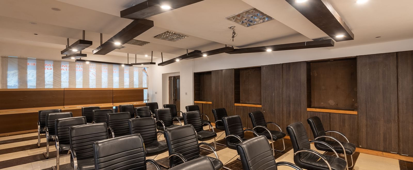 Conference Hall  at DLS Spring Valley Resort Dharamshala  with chairs and tables arranged in theater setting 
