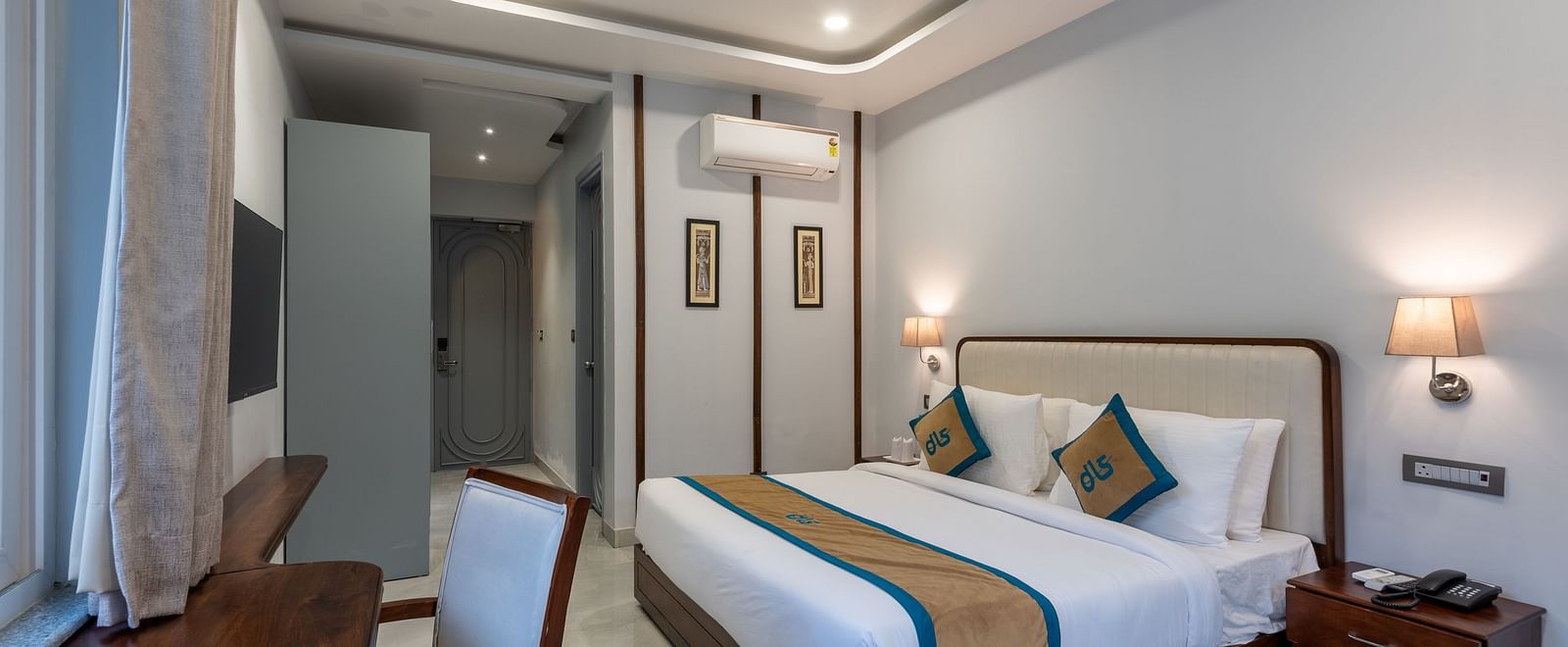 Overview of Spring Suite at DLS Spring Valley Resort Dharamshala featuring a kind bed, work desk and chair and ambient lighting