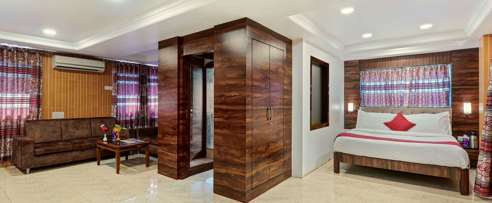Spacious suite at Mayur Retreat with a seating area, bright lighting, and contemporary decor.