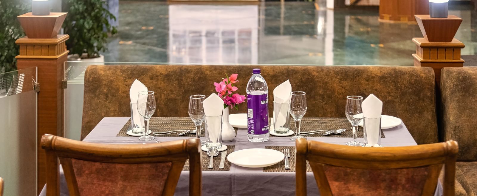 Cosy restaurant seating with elegantly set tables, and a warm ambience at Mayur Retreat.