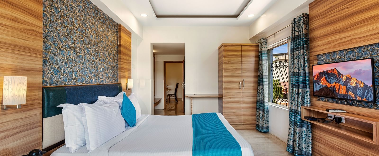 Stylish room at Mayur Retreat with elegant furnishings, blue-themed decor, and a serene ambiance.