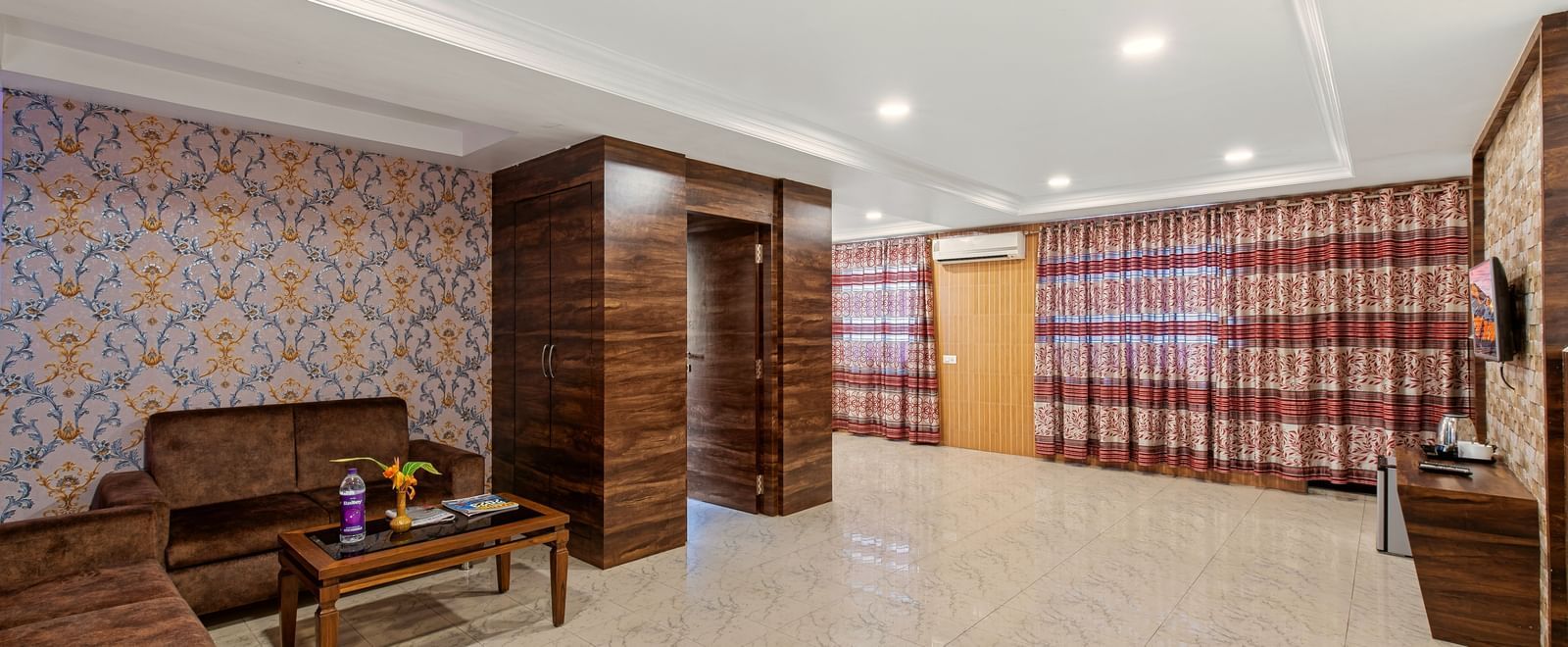 Spacious lounge or common area with seating, decorative wall patterns, and polished flooring at Mayur Retreat.