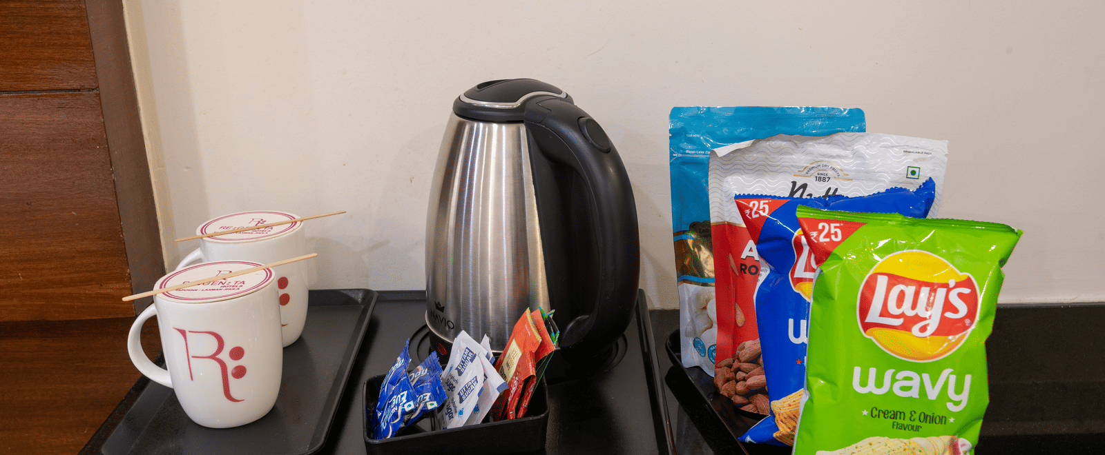 Tea and coffee maker with snacks at DLS Hotels On The Ganges.