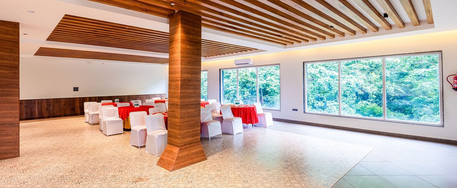 Banquet Hall at DLS Divine River Resort and Spa featuring  chairs table and a stage