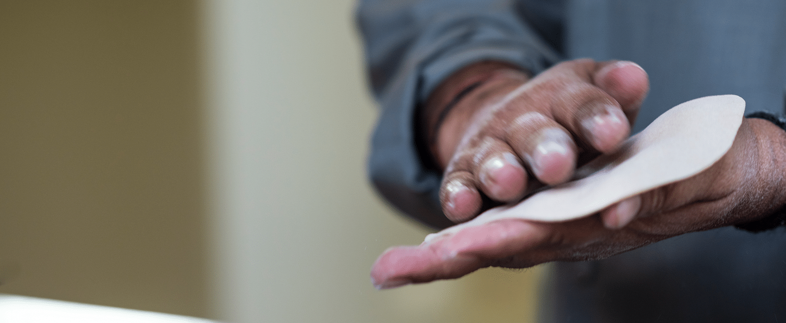 An image of a man making roti with his hands.