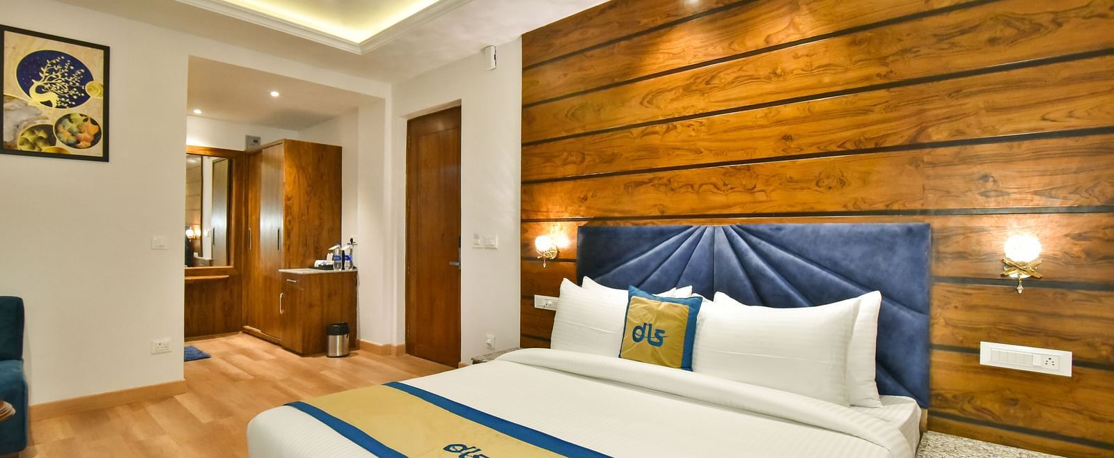 A large bed in front of the TV in Deluxe Non-view Room at DLS Ark Holiday Inn, Banikhet.