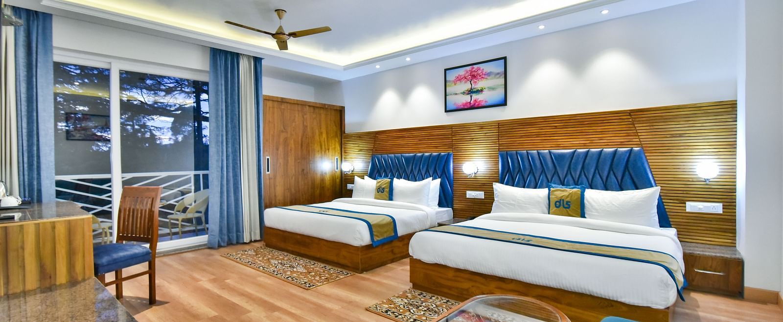 Two large beds with elegant interiors and ambient lighting in Family Suite Room at DLS Ark Holiday Inn, Banikhet.