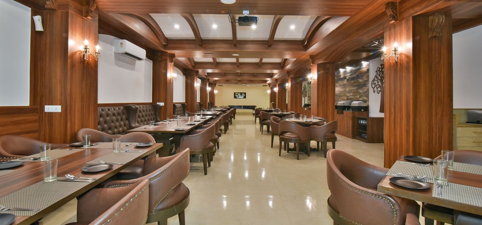 Dining seating with comfortable chairs around table at Ruttba at DLS Highland Resort and Spa, Mussoorie.