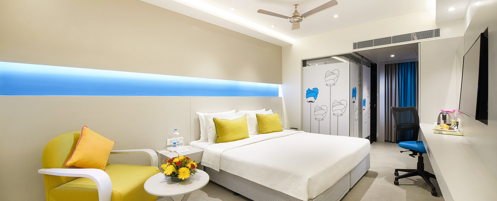 side view of a bedroom with a wall painting at  Zibe Salem by GRT Hotels