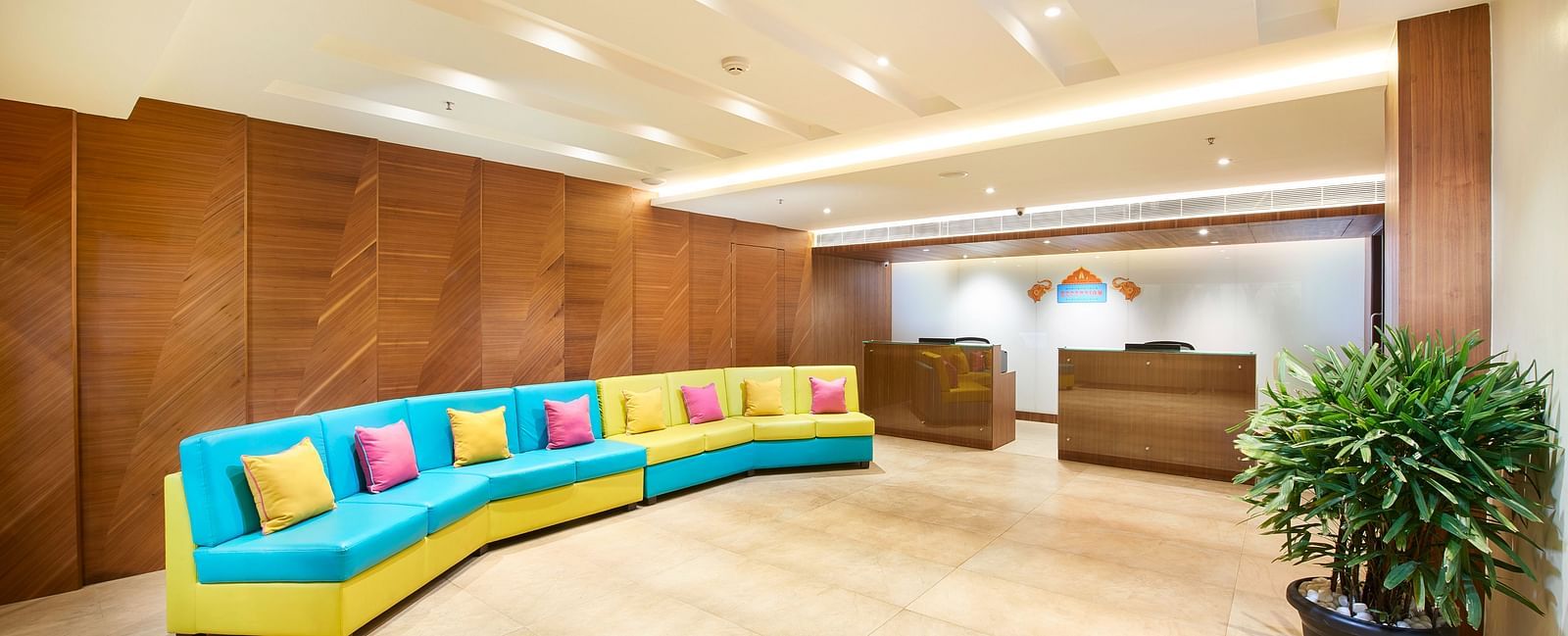 an image of the reception space with multicoloured sofa at Zibe Salem by GRT Hotels