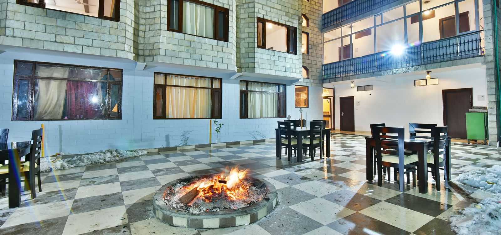 Exterior image of DLS Kapoor Resort Manali featuring a bonfire during the night.