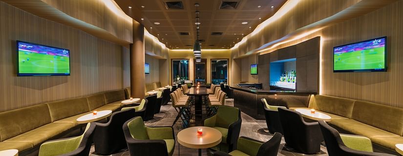 An image of the bar at the Pride Elite Phaltan with its seating arrangement and decorative lighting