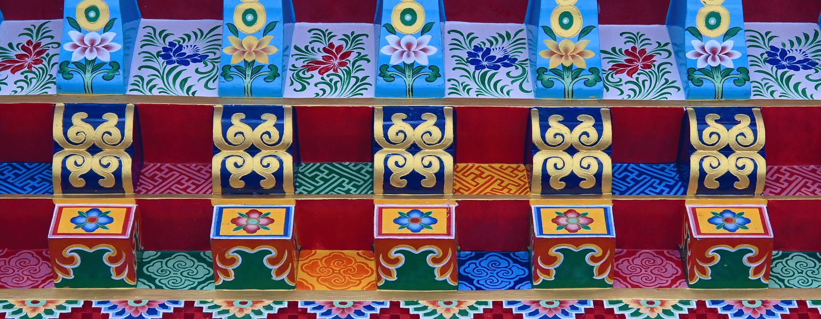 a close up of Enchey Monastery's building with colourful paints on it