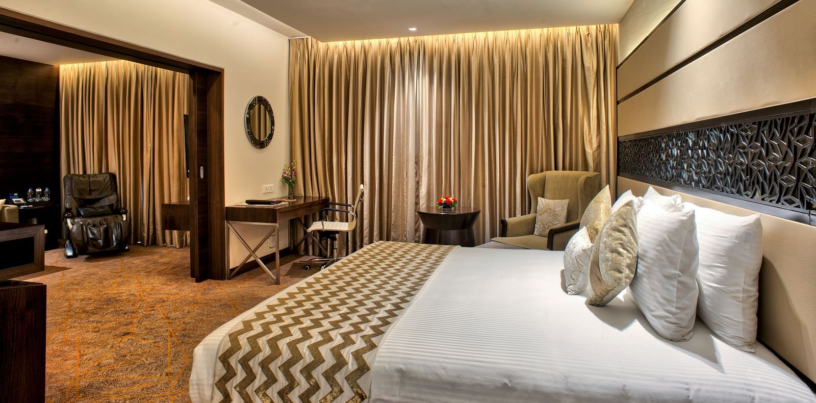 Image of the theme suite featuring a king size bed  and a seating arrangement at Grand Chennai by GRT hotels