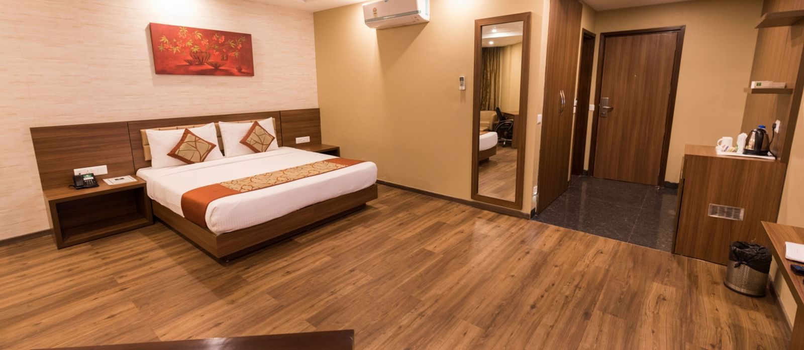 Super Deluxe Rooms with Complimentary Wi-Fi captured with a cosy bed and white linens along with a beige couch - Le ROI Digha Hotel West Bengal6