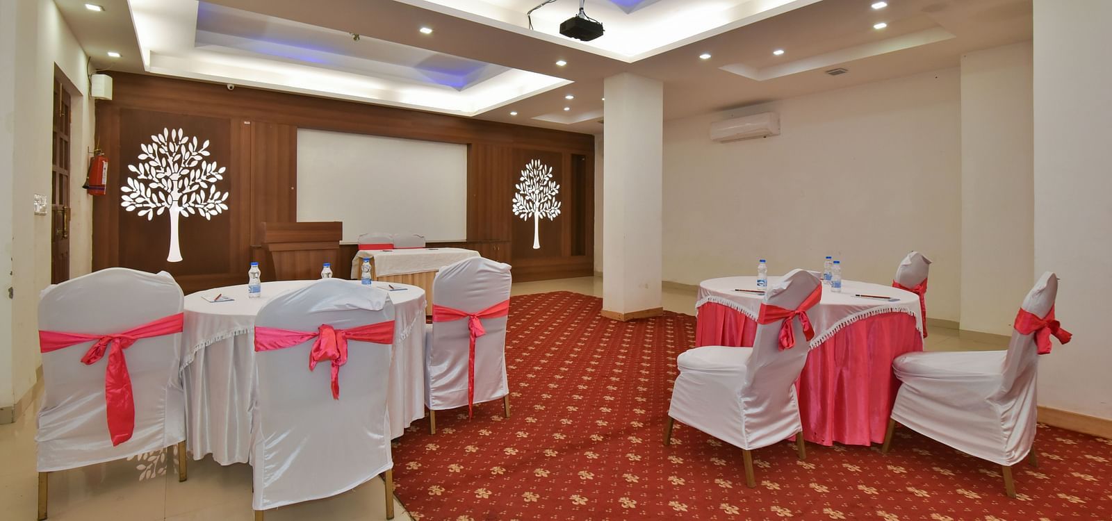 A conference hall with comfortable chairs facing the podium at DLS Highland Resort and Spa, Mussoorie.